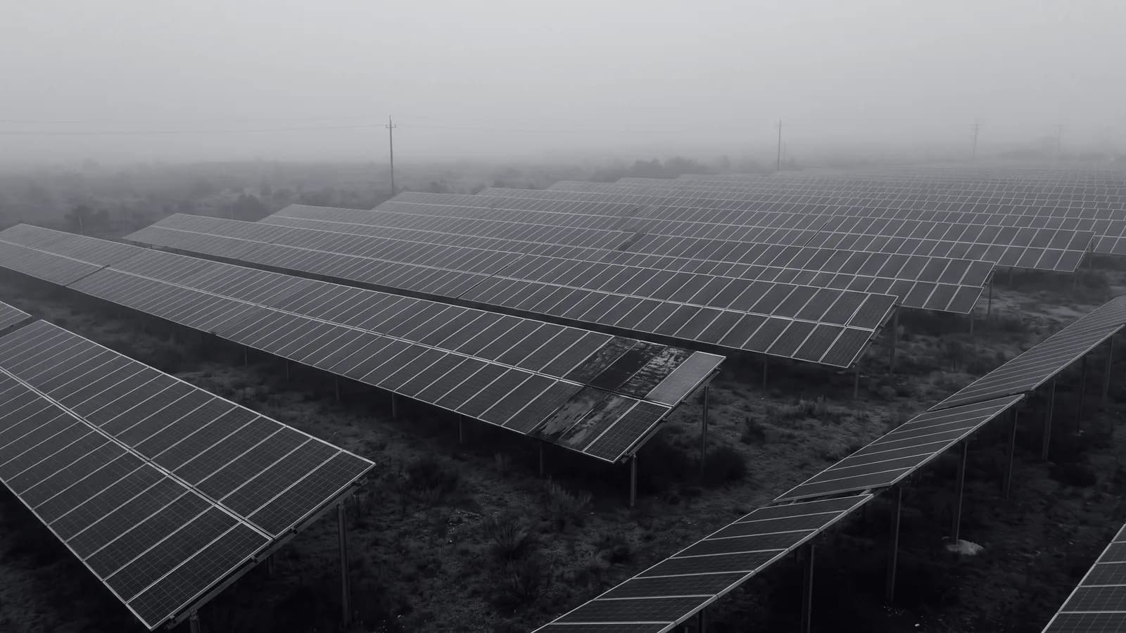 Illustrative frame: an aerial view of a solar array, with computer vision isolating two underperforming panels from the ranks of sound ones around them. Shown in black and white, with the annotated regions revealed in colour.